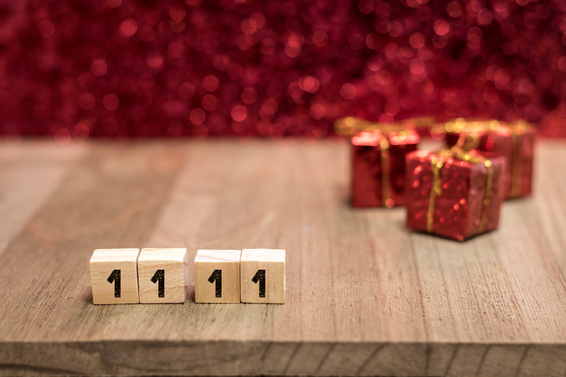 Dice showing 1111, symbolizing Singles Day, with a gift wrapped package