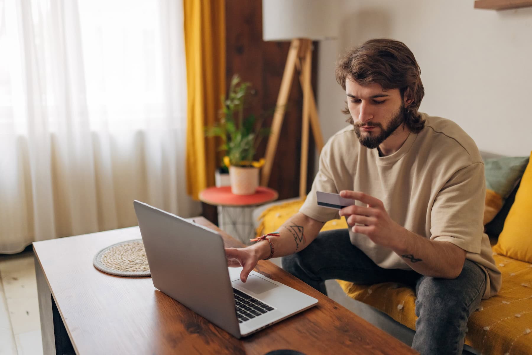 shopper on his sofa looking puzzled to illustrate Signifyd's 3DS Myths and Realities in America blog post