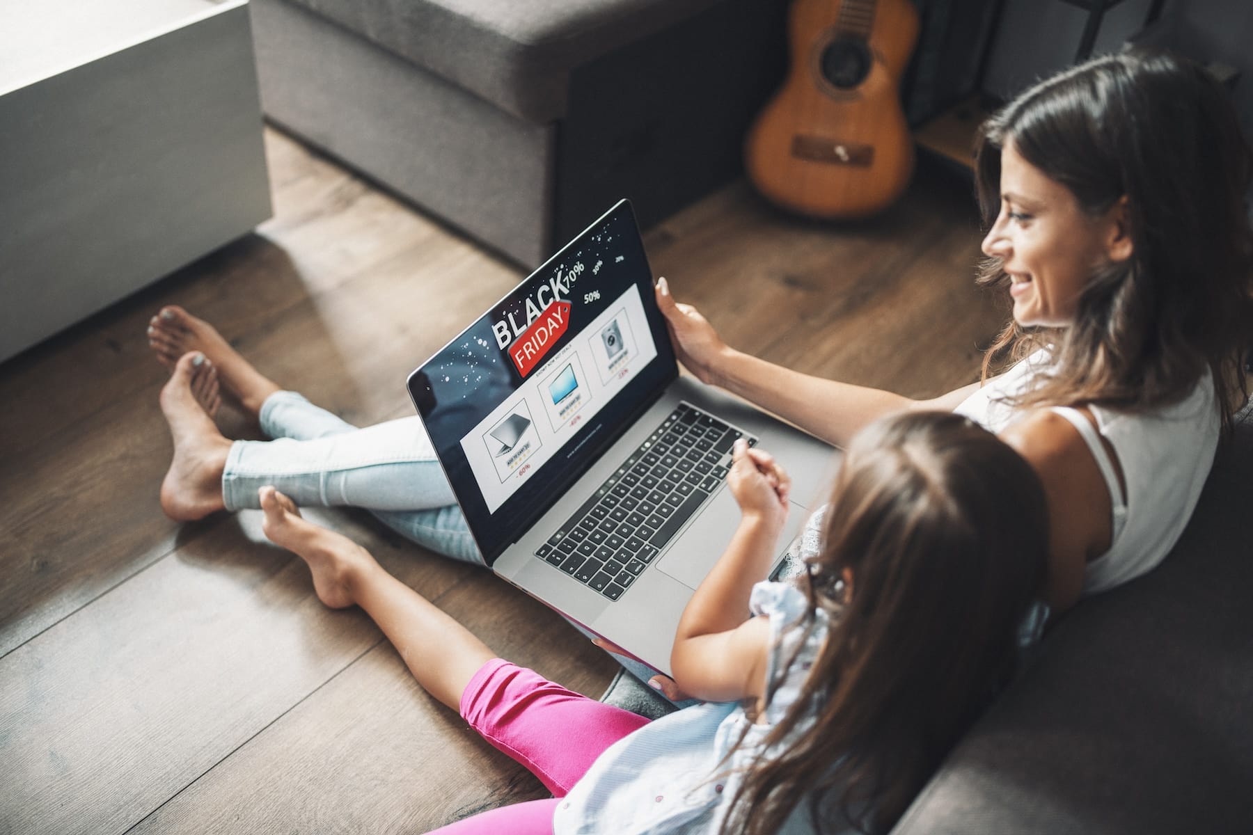 Mother and daughter shopping on a laptop on Black Friday