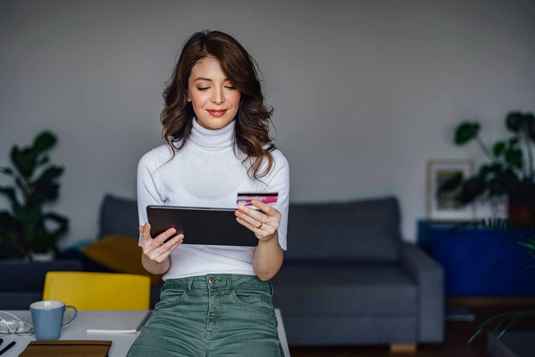 woman-computer-credit-card-happy-expert-signifyd