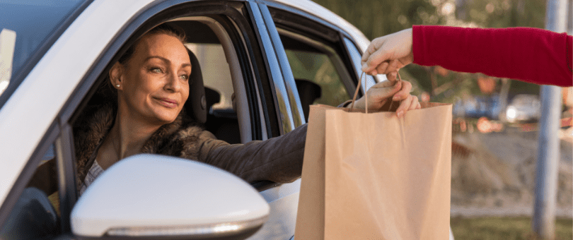Woman picking up at order at the curb