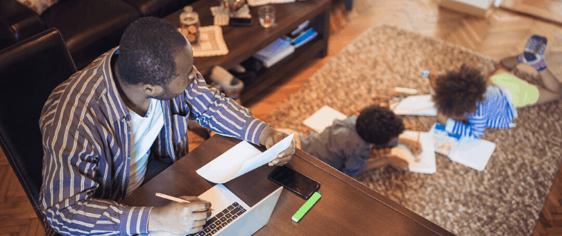 A dad working at home with his kids