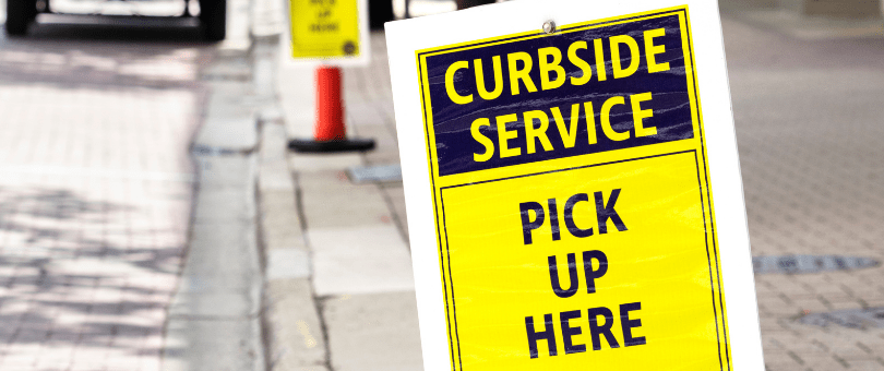Signs directing shoppers to curbside pickup areas