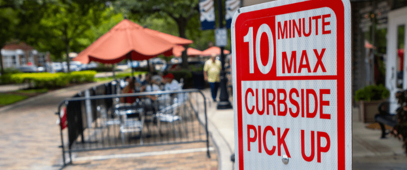 A sign that reserves parking for curbside pickup